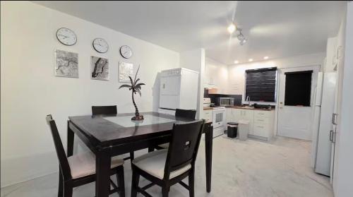 a kitchen with a table and chairs and a refrigerator at Private rooms in a shared two bedrooms apartment in Montréal