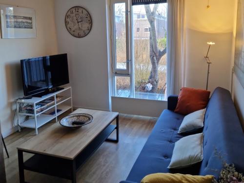 a living room with a blue couch and a table at Johan's B&B - Since 2014 roofterrace and cheap parking in Amsterdam