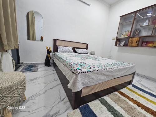 a bedroom with a bed with a quilt on it at AnjuShyam HomeStay in Agra