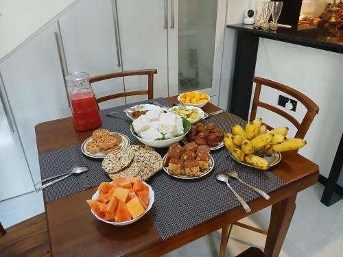 a table with a bunch of different types of food at Ceylon Good Vibes Villa in Dickwella