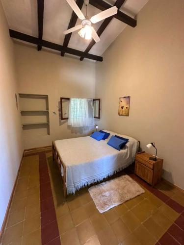 a bedroom with a bed and a ceiling fan at La Maguada in Tanti