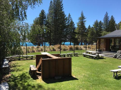 a group of picnic tables and benches in a park at Lakes Edge Lodge in Lake Tekapo