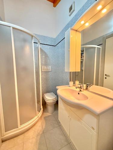 a bathroom with a shower and a sink and a toilet at Villa Chiara in Follonica