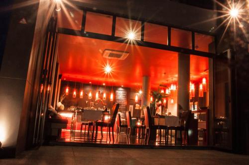 a restaurant with a bar with red lighting at The Houben - Adult Only in Ko Lanta