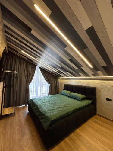 a bedroom with a bed and a coffered ceiling at Майя VIP in Mykulychyn