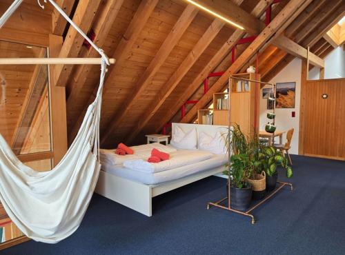 a room with a hammock in a attic at Haus am Wasserfall in Mellau