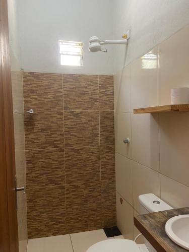 a bathroom with a shower with a toilet and a sink at Beach Chalet Preá in Prea