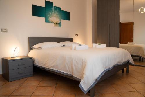 a bedroom with a bed with two towels on it at Urban Chic Apartment in Valmontone
