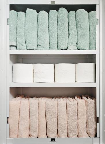 a closet filled with towels and toilet paper at Bokman stay 01 in Seoul