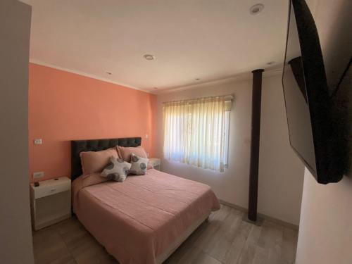 a bedroom with a bed with two pillows on it at FloreSer in Villa Gesell
