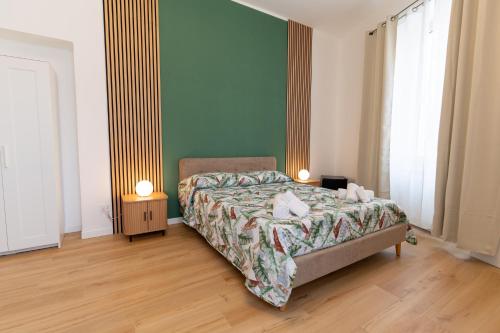 a bedroom with a bed with two lamps on it at Il Giardinetto Guest House in Civitavecchia