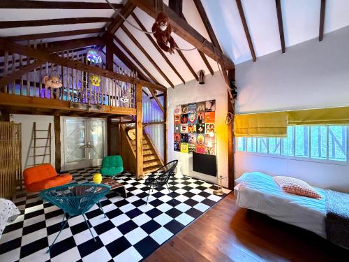 a room with a checkered floor and a room with a bed at Authentique villa du XIX e siècle avec piscine in Lue