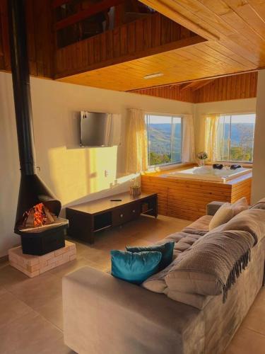 a living room with a large bed and a fireplace at Quinta Sol Montês in Rancho Queimado