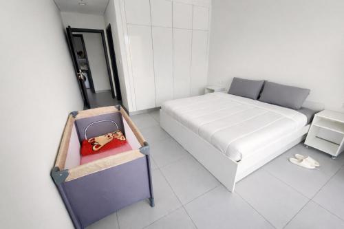 a small bedroom with a bed with a toy bear on it at New Large 2BR Apt Sleeps 10 Adults with Pool Gym Parking and Wifi in Dubai