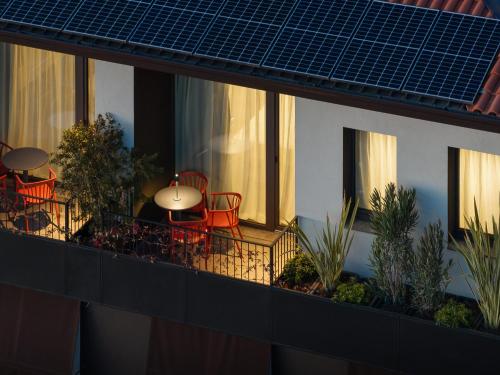 a balcony with a table and chairs on it at El Cielo - Rooms with Panoramic View & El Carnicero Restaurant in Cornedo Vicentino