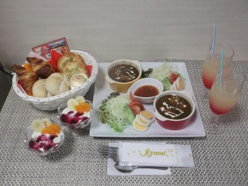 a table with a plate of food and a bowl of food at HOTEL W-PREMIUM -W GROUP HOTELS and RESORTS- in Koshigaya