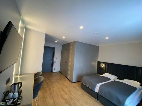 a hotel room with a bed and a television at Готель Поляницький in Bukovel