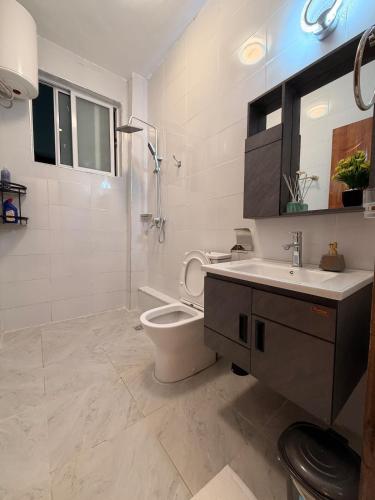 a bathroom with a toilet and a sink at Kijani Luxury Beach apartment in Malindi