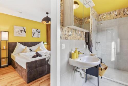 a bedroom with a bed and a sink and a shower at Luxury Long-Term Apartment with Terrace in Vienna