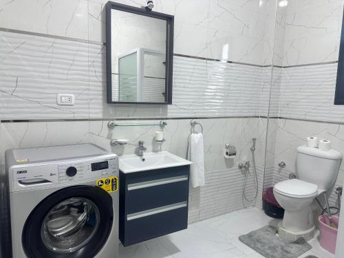 a bathroom with a washing machine and a sink at Hamed's House Luxor in Luxor