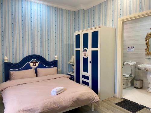 a bedroom with a bed with a blue and white stripes at Sa Villa Da Lat in Da Lat