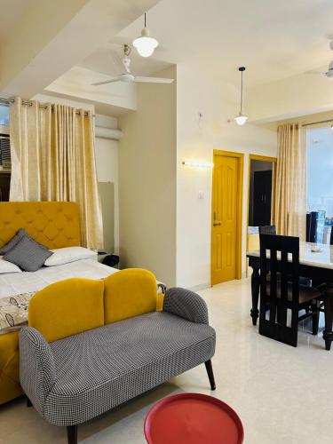 a bedroom with a bed and a couch and a table at Pitambar in Varanasi