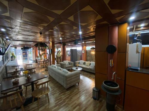 a living room with a couch and a dining room at Hotel Saphir Group in Douala
