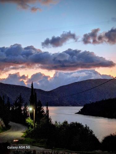 a view of a river with a sunset in the background at Foki Beach House in Fiskardo