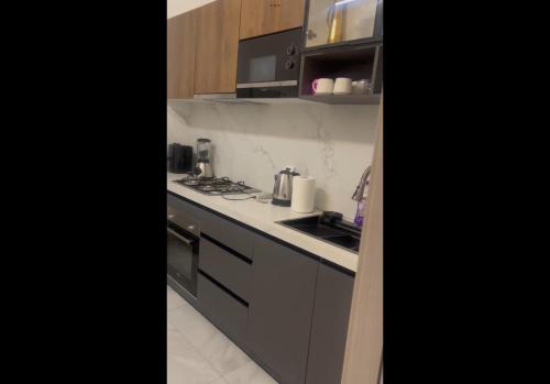 a kitchen with a sink and a stove top oven at Sélénite in Dakan