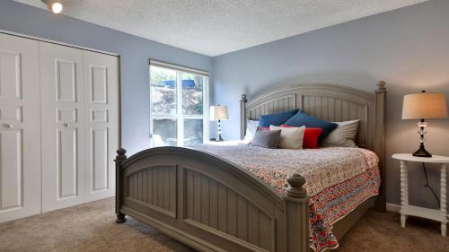 a bedroom with a bed with blue walls and a window at Beachfront Condo - Mutiny Bay by AvantStay Views in Freeland