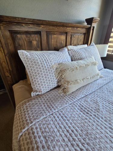 a bed with blue and white blankets and pillows at Guest House Suite Phoenix-Cave Creek in Phoenix