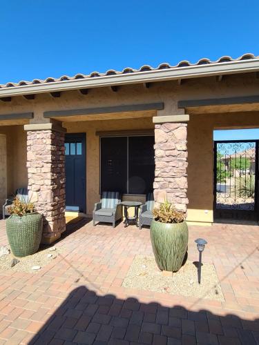 a patio with two large pots in front of a house at Guest House Suite Phoenix-Cave Creek in Phoenix