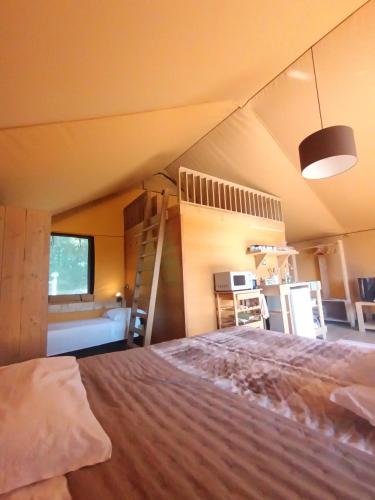 a bedroom with a bunk bed and a ladder at Glamping Podere Poggiagrilli in San Gervasio