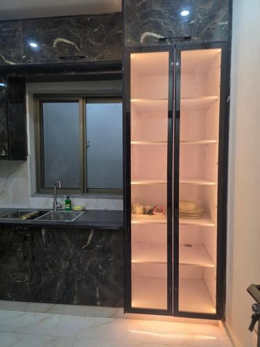 a refrigerator with its door open in a kitchen at Bahria enclave sect N in Islamabad