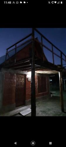 a night view of a building with a rooftop at Casita Walden in Cosquín