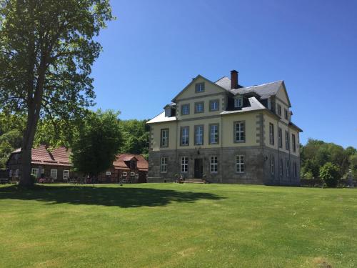 a large house on a large grassy field at Jagdschloss Walkenried - Hotel Residenz in Walkenried