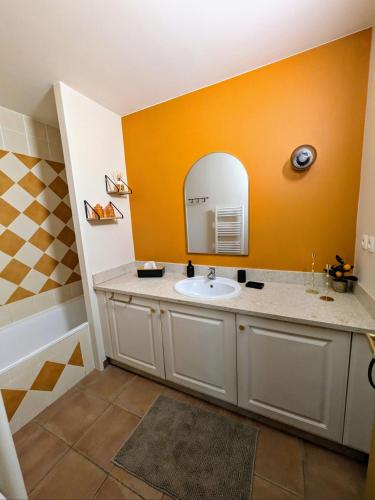 a bathroom with a sink and a mirror at Golf apartment in Saumane-de-Vaucluse