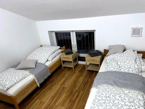 a room with three beds and two windows at Laichingen Center with style & tranquility in Laichingen