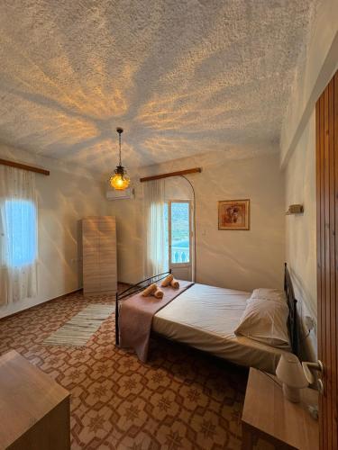 a bedroom with a bed with a ceiling covered in clouds at Villa Arginonta in Kalymnos