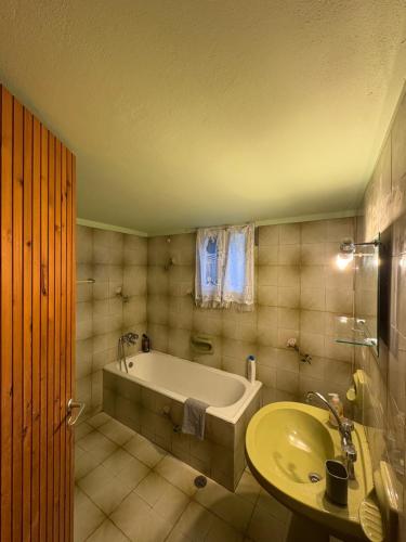 a bathroom with a tub and a sink at Villa Arginonta in Kalymnos