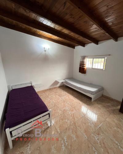 a bedroom with a bed in a room with a wooden ceiling at Departamento del Tuyu in Mar del Tuyú