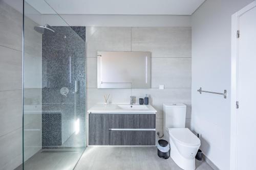 a bathroom with a toilet and a sink and a shower at Paradise Pereira House BY YOUR KEY MADEIRA in Calheta