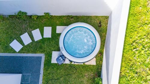 an overhead view of a swimming pool in the grass at Paradise Pereira House BY YOUR KEY MADEIRA in Calheta