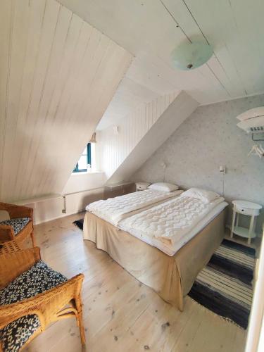 a bedroom with a large bed in a attic at Branteviks Viste in Brantevik