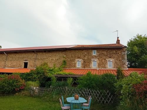 a person sitting at a table in front of a building at CAMPA'Gite in Toiras