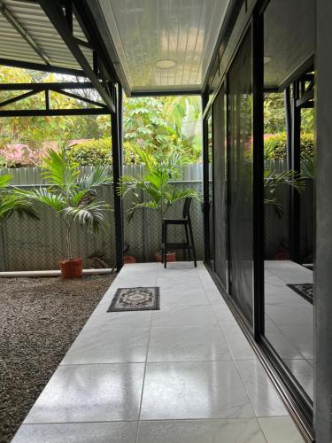 a porch of a house with a chair and plants at Apartamentos zafiro in Bahia