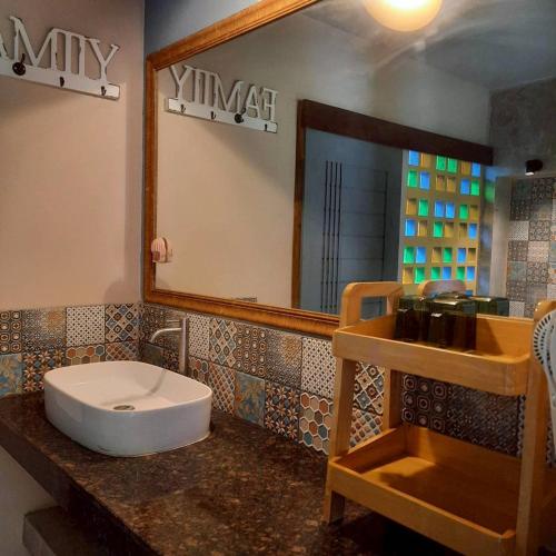 a bathroom with a sink and a mirror at The Leaf Pool Villa Resort in Muak Lek District