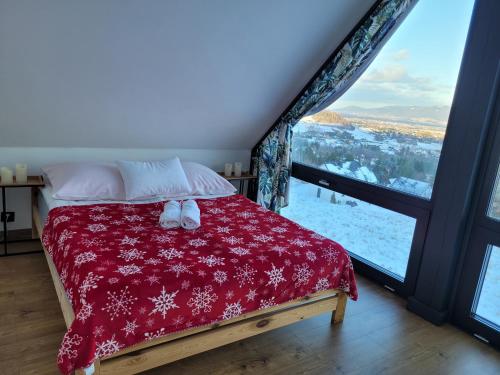 a bed in a room with a large window at Ostre Natura in Ostre