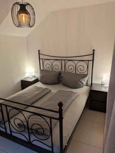 a bedroom with a black bed with two night stands at Ferienwohnung Leitner in Grins