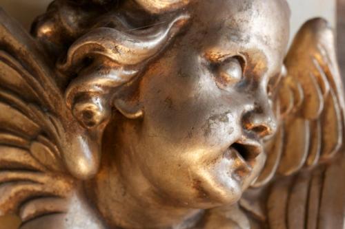 a gold statue of an angel on a wall at Le relais de saint Jacques in Boulogne-sur-Mer